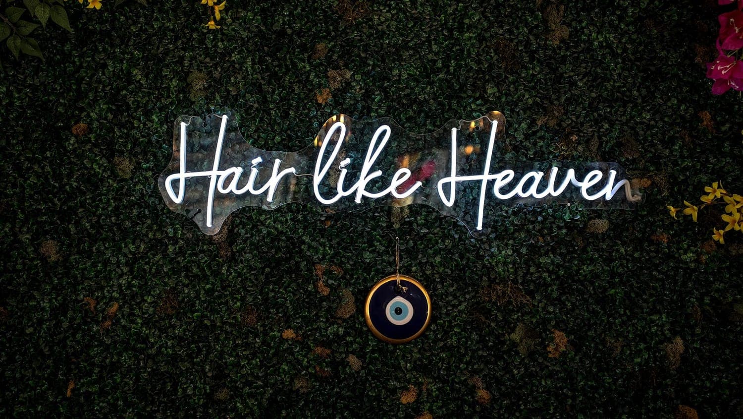 The 'Hair like Heaven' neon on a greenery wall at House of Excellence 201